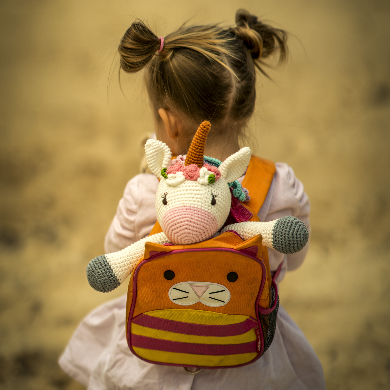 Crochet toy in girls backpack